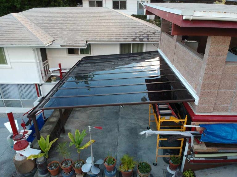 Attached roof aluminum patio cover seen from the side of a house