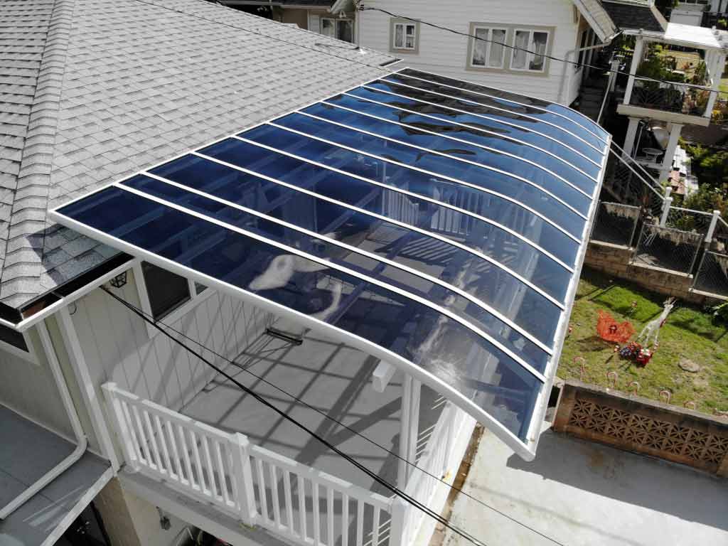 Curved roof aluminum patio cover attached to the house's roof.