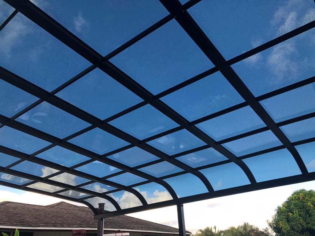 DIY aluminum carport with a curved roof.