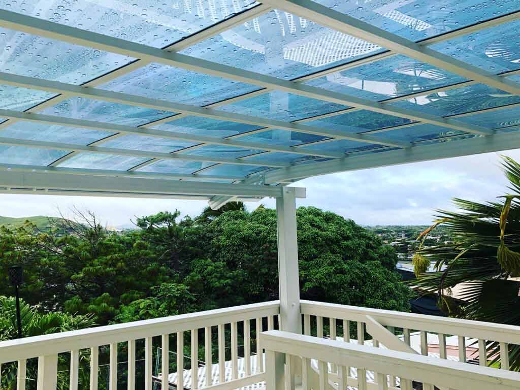 White aluminum patio cover protects the balcony from the rain